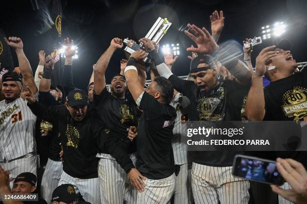 Leones del Caracas's players celebrate with the trophy after winning the Venezuelan Baseball League Championship Series against Tiburones de la...