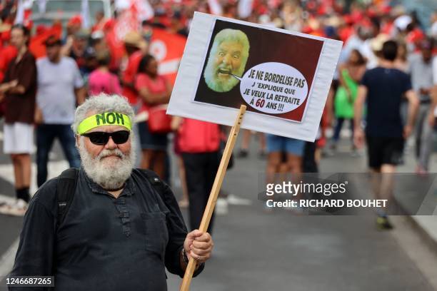 Protester holds a placard reading "I am not making a mess, I am explaining that I want to retire at 60 years old" on a second day of nationwide...