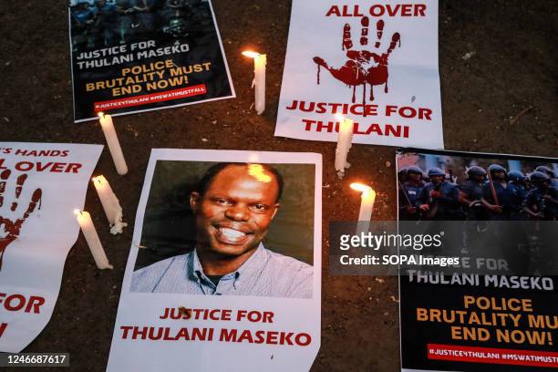 Lit candles beside posters with information decrying the assassination of Eswatini, formerly Swaziland, Human Rights Lawyer Thulani Maseko. Human...