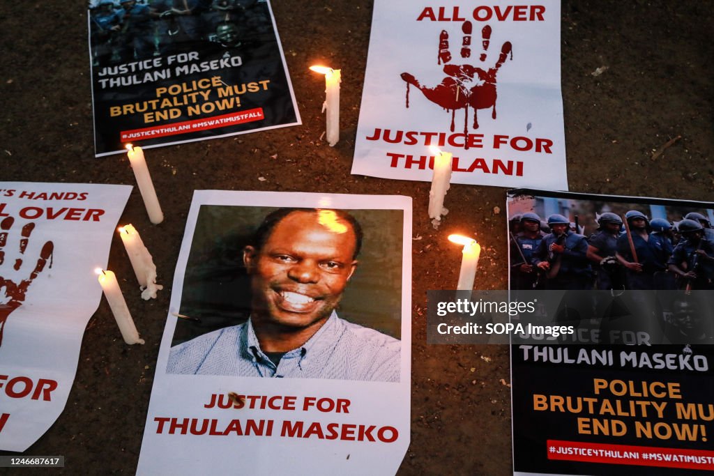 Lit candles beside posters with information decrying the... News Photo ...