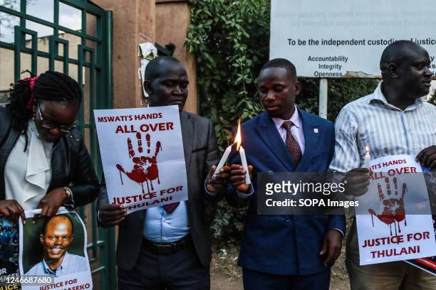 Activists light candles while holding posters to pay tribute to the assassinated Eswatini, formerly Swaziland, Human Rights Lawyer Thulani Maseko in...