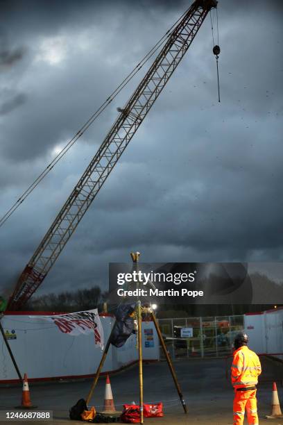 Protester sits on top of a tripod to block access to construction workers in the shadow of a huge crane on January 31, 2023 in Full Sutton, United...