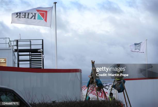 Protesters sit on top of tripods to block access to construction workers on January 31, 2023 in Full Sutton, United Kingdom. Activists say they are...