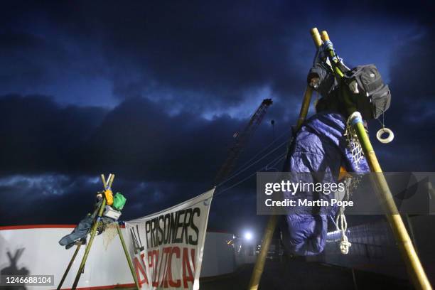 Protesters sit on top of tripods to block access to construction workers on January 31, 2023 in Full Sutton, United Kingdom. Activists say they are...