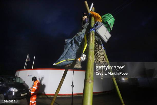 Before daybreak a protester sits on top of a tripod to block access to construction workers on January 31, 2023 in Full Sutton, United Kingdom....