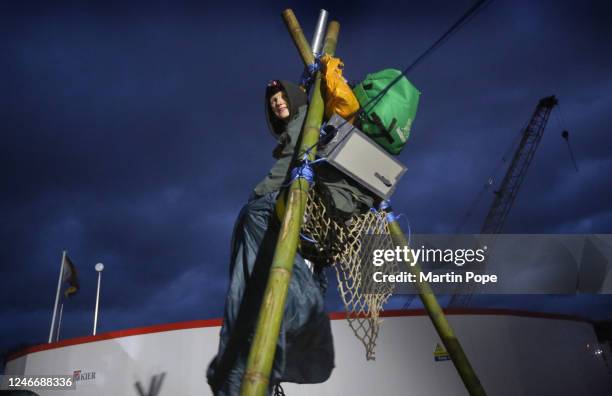 Before daybreak a protester sits on top of a tripod to block access to construction workers on January 31, 2023 in Full Sutton, United Kingdom....
