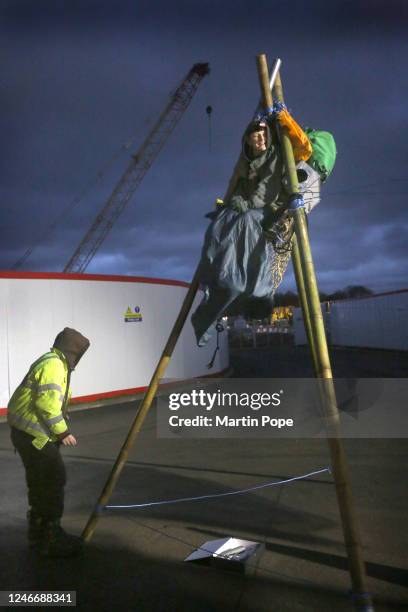 Protester sits on top of a tripod to block access to construction workers traffic on January 31, 2023 in Full Sutton, United Kingdom. Activists say...