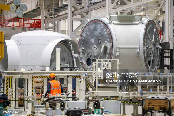 Worker stands next to rotor hubs of wind turbines at the Siemens Gamesa factory in Cuxhaven, northwestern Germany, on January 31 on the sidelines of...