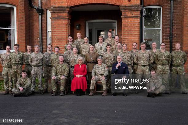 Camilla, Queen Consort and Colonel of the Grenadier Guards, poses for a group photo as she visits Lille Barracks on January 31, 2023 in Aldershot,...