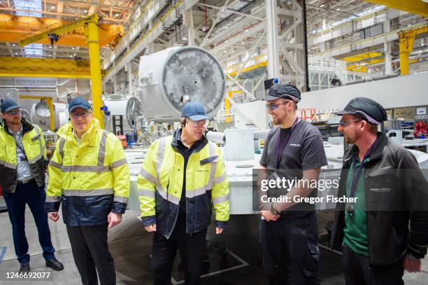 German Federal Economy and Climate Action Minister Robert Habeck talks to workers while visiting the Siemens Gamesa wind turbine factory on January...