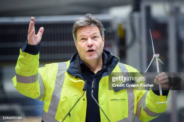 German Federal Economy and Climate Action Minister Robert Habeck holding a model wind turbine while visiting the Siemens Gamesa wind turbine factory...