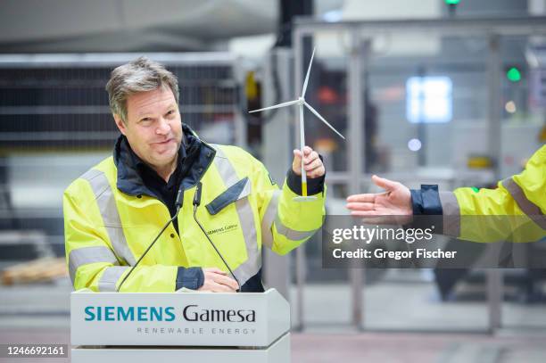 German Federal Economy and Climate Action Minister Robert Habeck gets a model wind turbine from Chief Executive Officer of Siemens Gamesa Renewable...