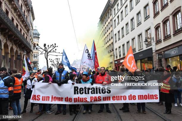 Protesters hold a banner reading 'Pensions, not one day more, not one euro less' as they march during a demonstration as part of a nationwide day of...