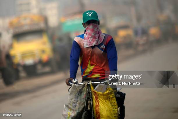 People make their move in a dusty busy road in Dhaka, Bangladesh on January 31, 2023. With an air quality index score of 291 at 8:45am on Tuesday,...