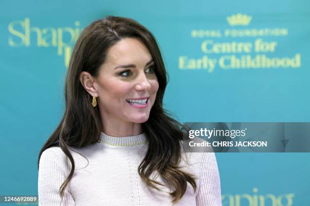 Britain's Catherine, Princess of Wales reacts as he meets with students and staff on the Childhood Studies BA course, during a visit to the...