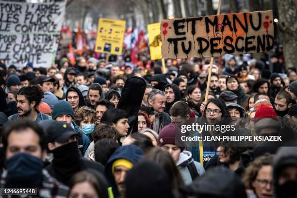 Protester holds a placard reading "Manu get down here !" during a demonstration as part of a nationwide day of strikes and rallies for the second...