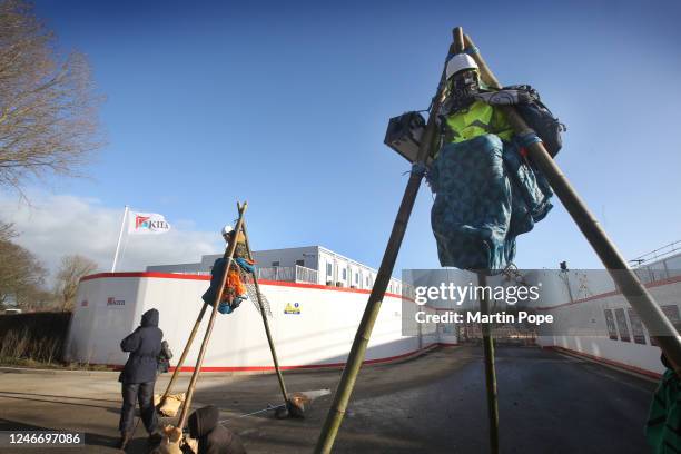 Protesters sit on top of a tripod to block access to construction workers on January 31, 2023 in Full Sutton, United Kingdom. Activists say they are...