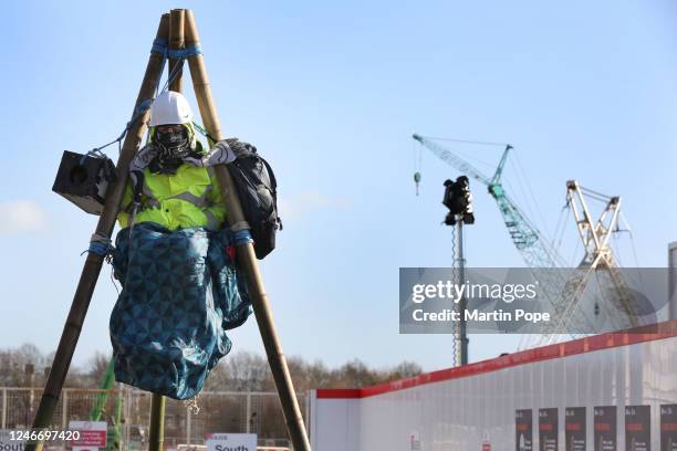 Protester sits on top of a tripod to block access to construction workers on January 31, 2023 in Full Sutton, United Kingdom. Activists say they are...