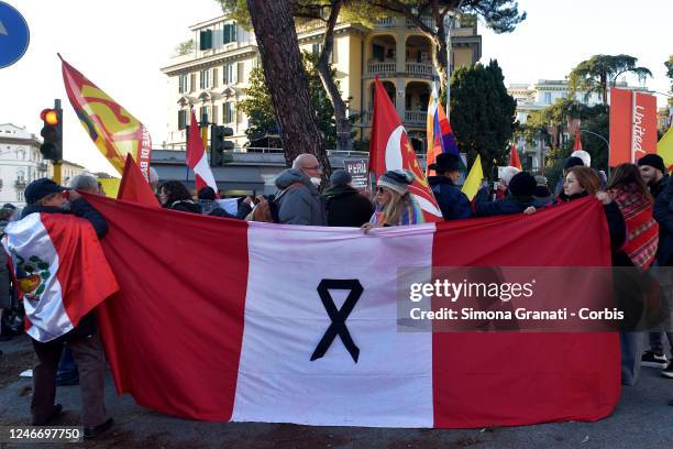 People protest in front of the Peruvian embassy in Italy with placards and banners against the Peruvian parliament accused of corruption and...