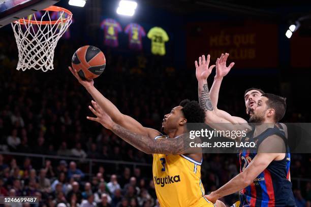 Maccabi Tel Aviv's US player Jalen Adams attempts a shot next to Barcelona's Argentinian guard Nicolas Laprovittola during the Euroleague basketball...