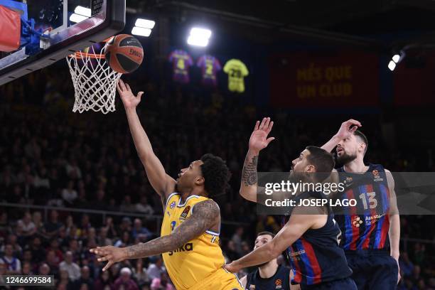 Maccabi Tel Aviv's US player Jalen Adams attempts a shot next to Barcelona's Argentinian guard Nicolas Laprovittola and Barcelona's Czech guard Tomas...