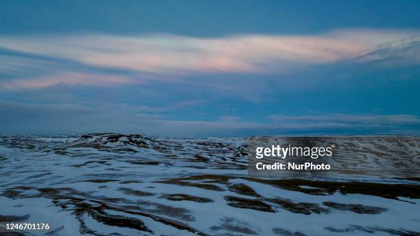 Drone view of polar stratospheric clouds, also known as nacreous clouds or mother-of-pearl clouds, were seen in the Fjaðrárgljúfur canyon in Iceland...