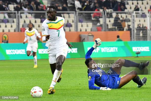 Senegal's forward Cheikh Ibra Diouf dribbles past Madagascar's goalkeeper Zakanirina Rakotoasimbola during the 2022 African Nations Championship...