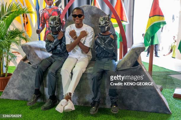 Guyanese actress Letitia Wright poses for a picture with children at the Patentia Primary School in Georgetown on January 31, 2023. - Letitia Wright...
