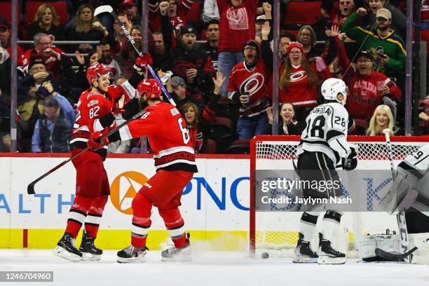 Brent Burns of the Carolina Hurricanes and Jesperi Kotkaniemi celebrate a goal during the first period of the game against the Los Angeles Kings at...