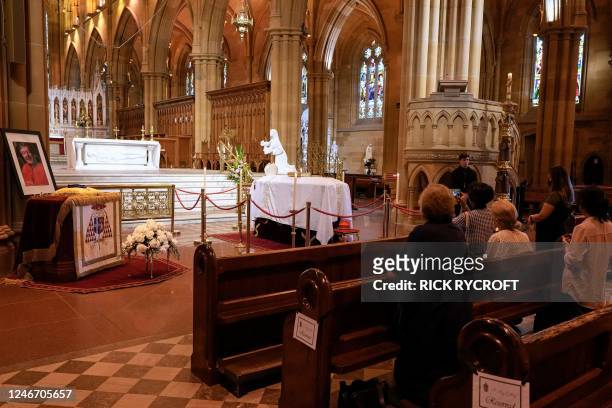 People attend a prayer vigil for Australian Catholic cardinal George Pell as he lies in state at St Mary's Cathedral in Sydney on February 1, 2023. -...