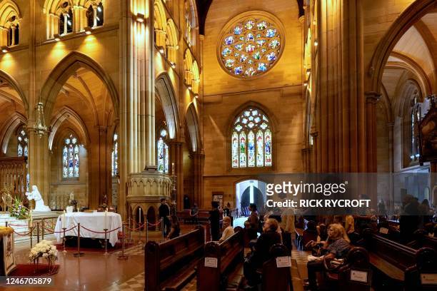 People attend a prayer vigil for Australian Catholic cardinal George Pell as he lies in state at St Mary's Cathedral in Sydney on February 1, 2023. -...