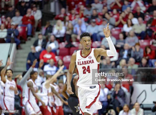 Brandon Miller of the Alabama Crimson Tide points a finger after knocking down a second half three pointer against the Vanderbilt Commodores at...