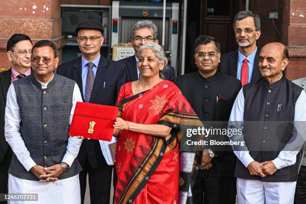 Nirmala Sitharaman, India's finance minister, center, and other members of the finance ministry leave the ministry to present the budget at the...