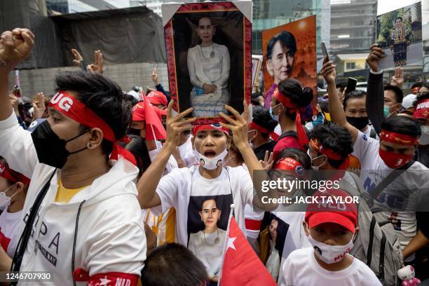 Protesters hold images of detained civilian leader Aung San Suu Kyi during a demonstration outside the Embassy of Myanmar in Bangkok on February 1 to...