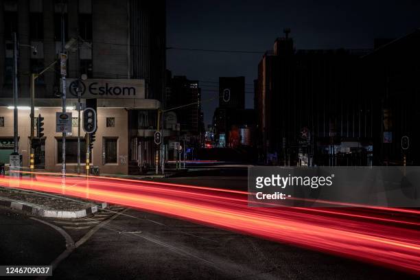 General view shows trails of lights from passing vehicles in Braamfontein, Johannesburg that is submerged in darkness due to load-shedding on 31...