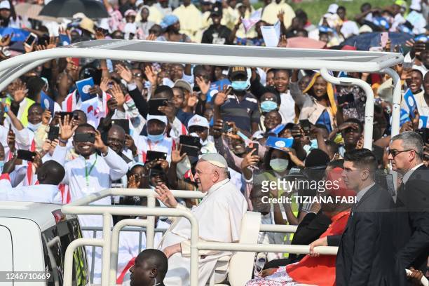 Pope Francis waves as he arrives by popemobile for the mass at the N'Dolo Airport in Kinshasa, Democratic Republic of Congo , on February 1, 2023.