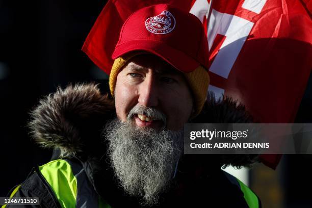 Railway worker takes part in a picket line called by the British trade union ASLEF in front of the Reading train station, as part of a national...