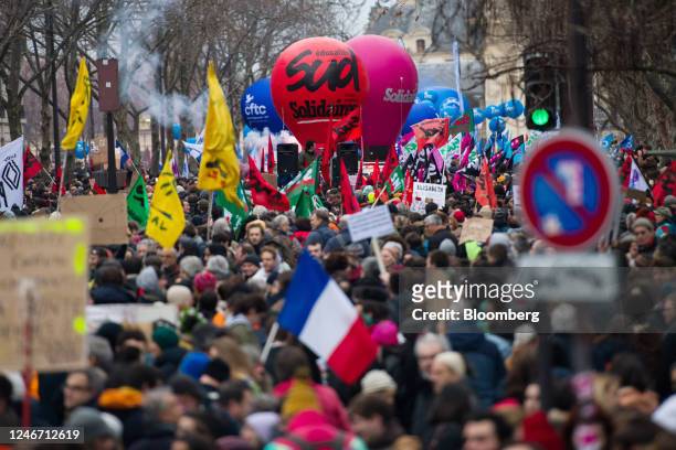 Demonstrators march along Boulevard Raspail at a protest during a strike against government plans to revamp the pension system, in Paris, France, on...