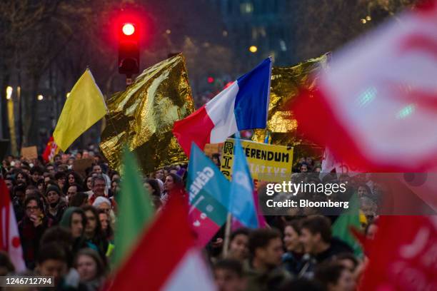 Demonstrators march along Boulevard Raspail at a protest during a strike against government plans to revamp the pension system, in Paris, France, on...