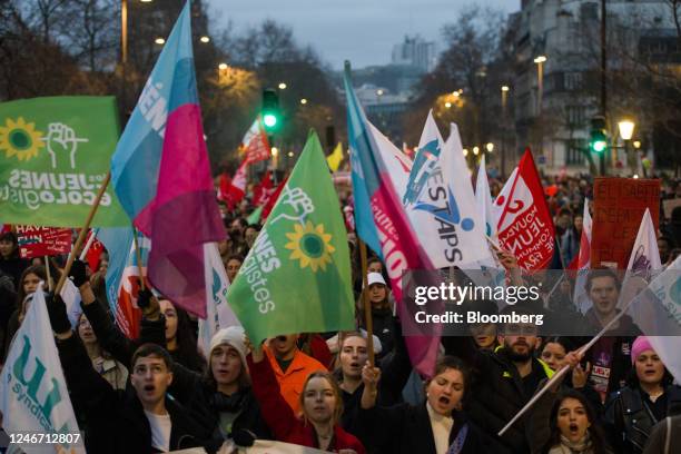 Demonstrators march along Boulevard Raspail at a protest during a strike against government plans to revamp the pension system, in Paris, France, on...