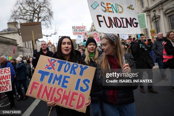 Teachers hold placards as they take part in a protest organised NEU and other affiliated trade unions in central London, on February 1, 2023. -...