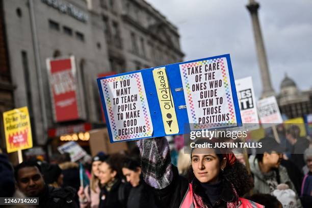 Teacher holds a placard while shouting slogans during a protest organised NEU and other affiliated trade unions in central London, on February 1 as...