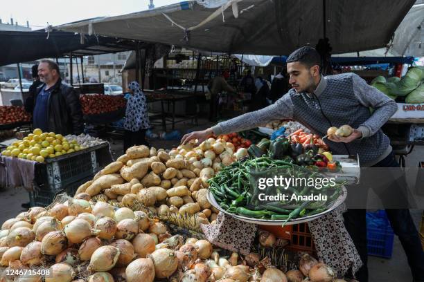 Seller prepares products for sale at his counter at the public market as daily life continues in Rafah, Gaza on February 01, 2023. Palestinians, who...