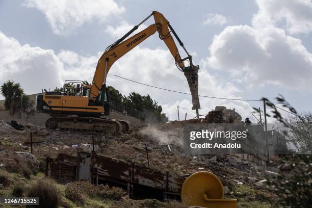 Heavy duty machine of Israeli forces demolishes the house belonging to Palestinian Nasser Amera in the Wadi Al Homs area of ââEast Jerusalem on...