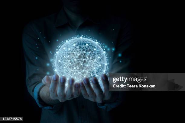 a man holds a globe that connects a network of information forwarding to the world, quick and easy forwarding information.and network connection a black background. - space craft stock pictures, royalty-free photos & images