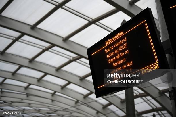 Photograph taken on February 1, 2023 shows a board warning about an industrial action at Victoria Station in Manchester, during a national strike...
