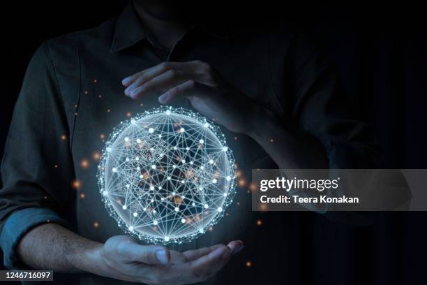 businessman embraces the world with information all over the world through high-speed internet access.quick and easy forwarding information and network connection concepton a black background. - medios visuales fotografías e imágenes de stock