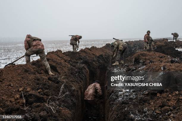 Ukrainian servicemen make a trench near Bakhmut on February 1 amid the Russian invasion of Ukraine.