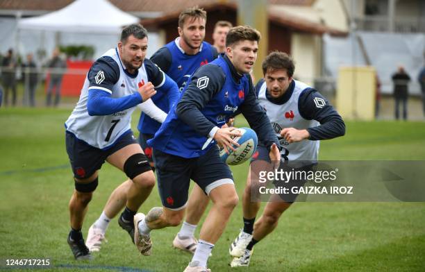 France's fly-half Matthieu Jalibert runs with the ball during a training session at the Bourret stadium in Capbreton on February 01, 2023...