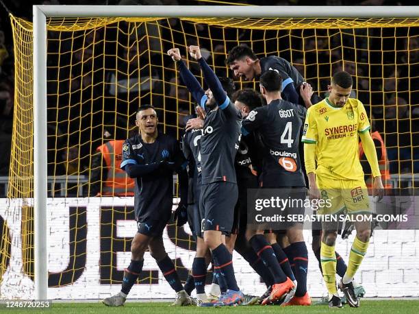 Marseille's players celebrate a first goal for their team scored by Nantes's defender Brazilian Joao Victor during the French L1 football match...
